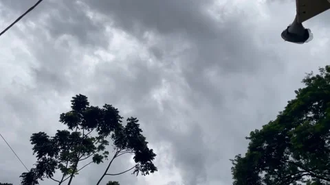 Dark Storm Clouds Over Rural Village Treetops and Megaphone Horn Stock-Footage 346237393