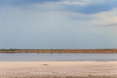 Dark storm clouds over a salt lake before a rain Stock Photos
