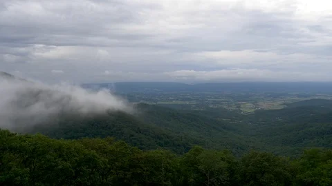 Dark storm clouds over Shenandoah Valley-clouds blow over forest near camera Video stock 111520505