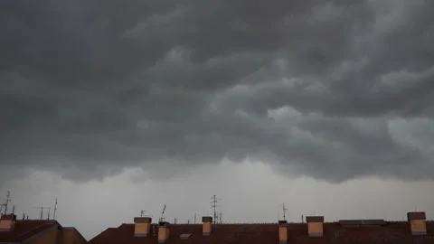Dark Storm Clouds Raced Overhead, Swirling Ominously As They Cast Shadows Over Stock Footage 327023478