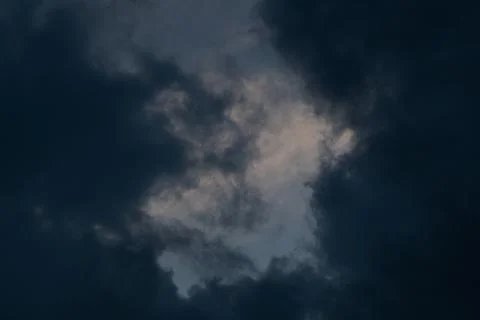 Dark storm clouds before rain. Bad weather, darkness, death. Stock Photos
