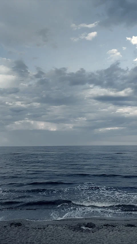 Dark storm clouds rain sea surface at sunset Nature Natural background Vertical Stock Footage 285371262