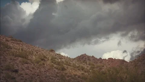 Dark storm clouds roll over a mountain in the Arizona desert Stock Footage 327827833