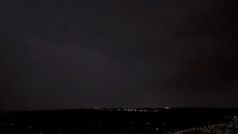 The dark storm clouds rolling in with bright electric lightning flashes over the Stock Footage 297099203