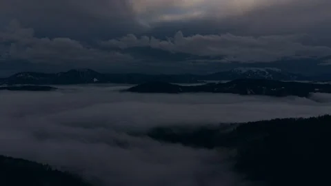 Dark storm clouds rolling over silent hills Video stock 328494312