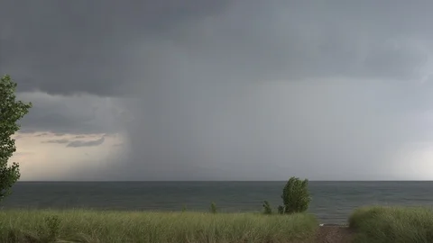 Dark storm clouds as severe thunderstorm rolls in over the lake Video stock 93009766