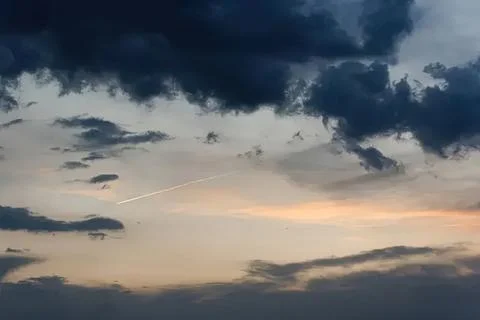 Dark storm clouds in the sky with a hint of sunset Stock Photos