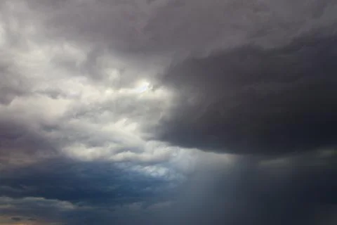 Dark storm clouds in sky before thunderstorm and rain. Dramatic sky background Stock Photos