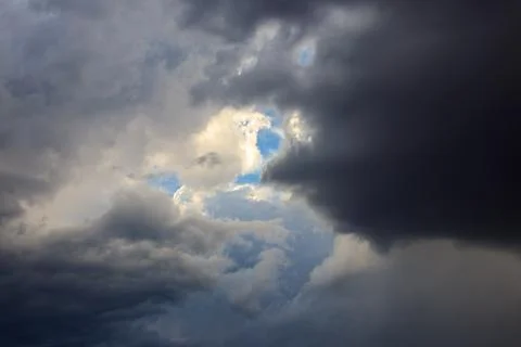 Dark storm clouds in sky before thunderstorm and rain. Dramatic sky background Stock Photos