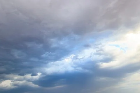 Dark storm clouds in sky before thunderstorm and rain. Dramatic sky background Stock Photos