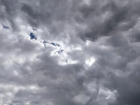 Dark Storm Clouds With Small Opening in Sky Stock Photos