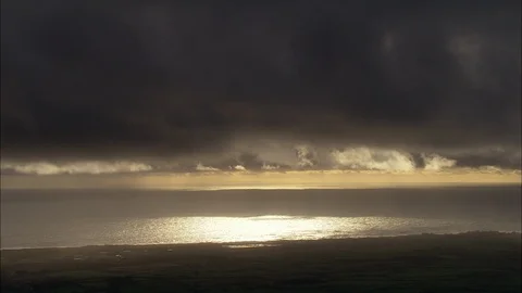 Dark stormy clouds above the sea at dusk, Sunlit Sea On Cumbrian Coast Stock Footage 108590945
