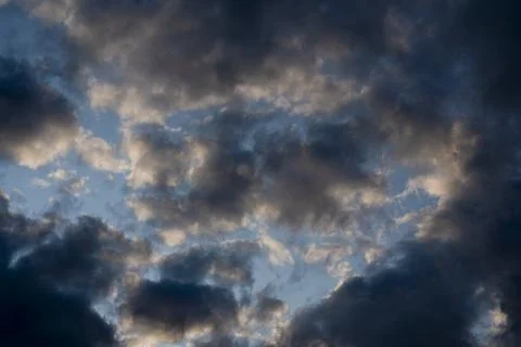 Dark Stormy Clouds and Blue Sky at Sunset Stock Photos
