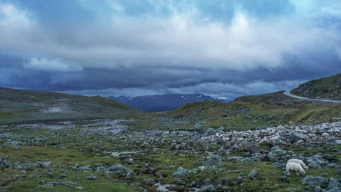 Dark stormy clouds are swirling above the desolate landscape of the Stock Footage 270073860