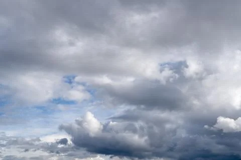 Dark stormy clouds moving across the dramatic sky Stock Photos
