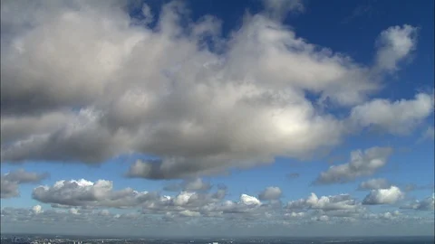 Dark stormy clouds on orange sky at sunset, Rich blue sky and fluffy white Stock Footage 109152936