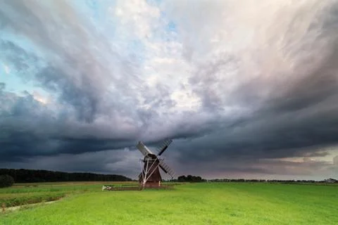 Dark stormy clouds over windmill Foto stock