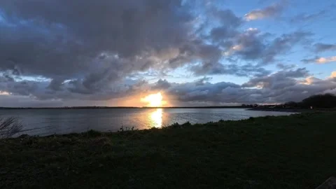 Dark stormy clouds time lapse heading towards golden sunset ocean horizon Stock Footage 325663328