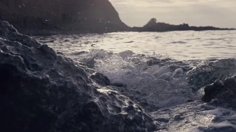 Dark stormy ocean waves crashing heavily against rugged coastal cliffs Stock Footage 337409287