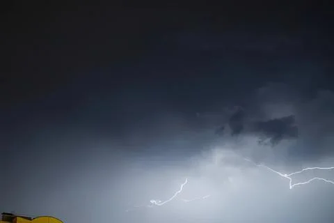 Dark stormy sky with lightning strikes during thunderstorm Stock Photos