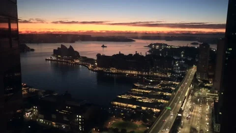 Dark sunrise over Sydney Harbour from elevation of Circular Quay waterfront 4k. Stock Footage 135307601