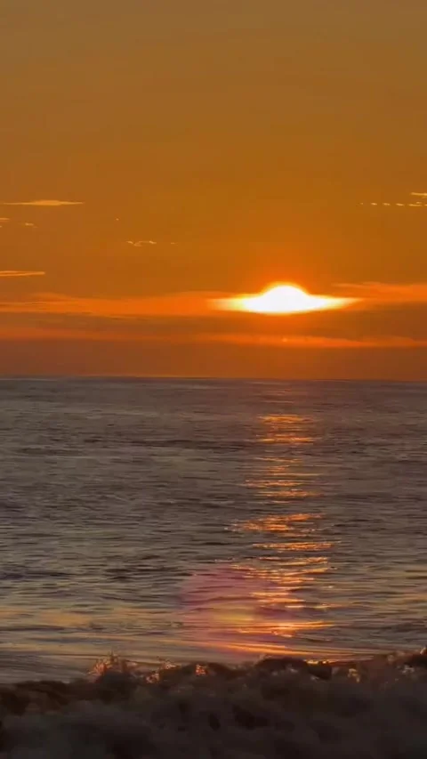Dark Sunset Over Ocean with Glowing Sun and Waves Stock Footage 341319222