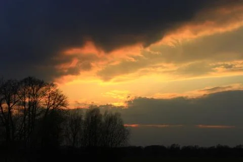Dark sunset with yellow clouds Stock Photos