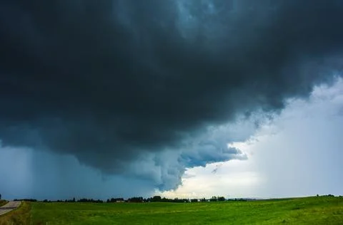 Dark supercell storm clouds with massive rain shaft. 스톡 사진
