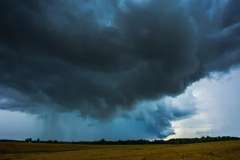 Dark supercell storm clouds with massive rain shaft. 스톡 사진
