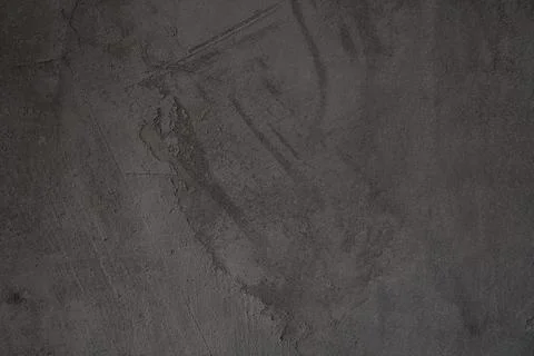 The dark surface is made of an old stone slab with an uneven natural pattern Stock Photos