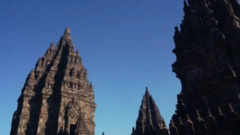 Dark temple edges frame soaring Prambanan spires in a dramatic low-angle co.. Stock Footage 341545210