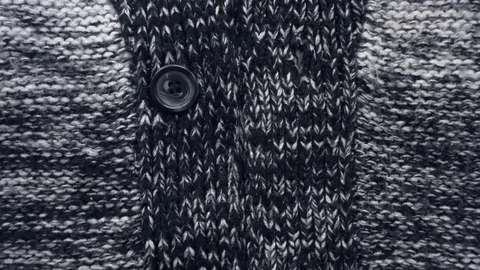 The dark texture of a knitted sweater. Buttons close up. Stock Footage 111565040