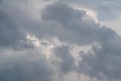 Dark textured clouds gathering overhead, heavy cumulonimbus forms with broodi 写真素材