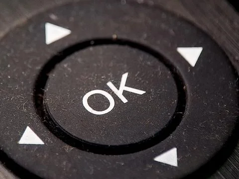 A dark textured control button showcases the symbol "OK" and directional ar.. Stock Photos