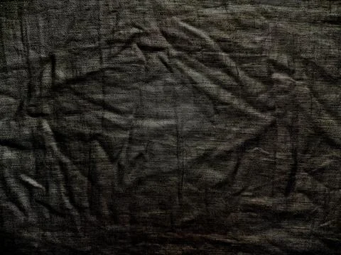 Dark textured fabric background with dramatic shadows and wrinkled organic li 写真素材