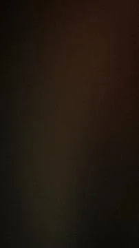 Dark textured grainy background vertical format with black brown and dark r.. Stock Photos