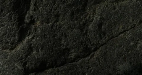 Dark Textured Rock Surface Close-Up Stock Footage 293007659