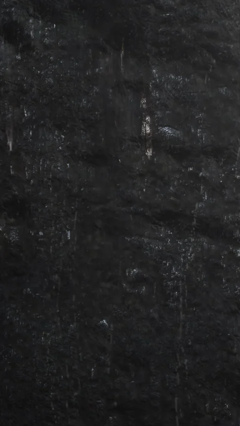 Dark Textured Rock Surface, Closeup Of Gritty Black Stone With Damp Patches Stock Footage 324876574
