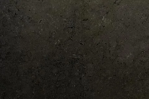 Dark textured stone surface highlighting natural patterns and subtle variations Stockfoto's