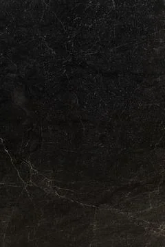 Dark textured stone surface with subtle patterns and natural imperfections Stock Photos