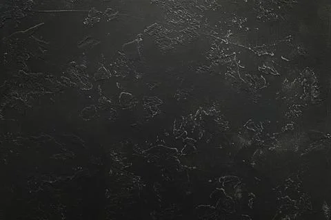 Dark textured surface with abstract markings and subtle rough patterns Foto stock