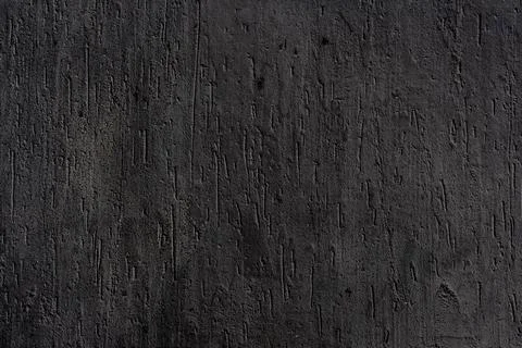 Dark, textured surface that appears Stock Photos