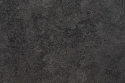 Dark textured surface with subtle patterns and a crack highlights the beauty of Foto stock