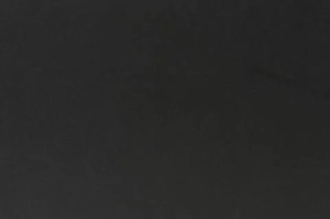 Dark textured surface with subtle variations highlighting its features and .. Stock Photos