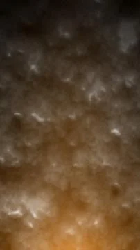 Dark textured surface with warm orange lighting gradient creating a smoky, .. Stock Photos