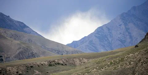 Dark thundercloud over a mountain pass before the weather worsens. Stock Photos