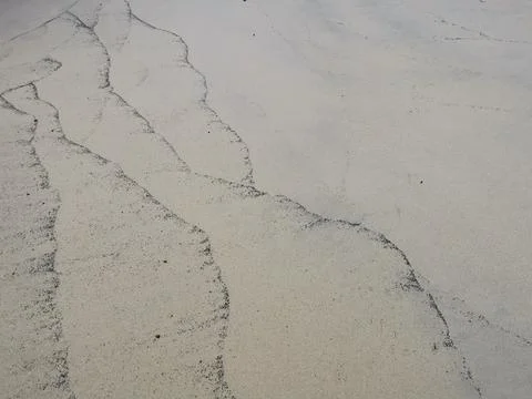 Dark tide mark on dull sandy beach with space for copy Stock Photos