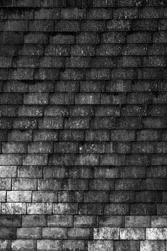 Dark Tiled Wall with Diagonal Shadows Stock-Fotos