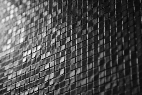 Dark tiles mosaic pattern on a wall Stock Photos