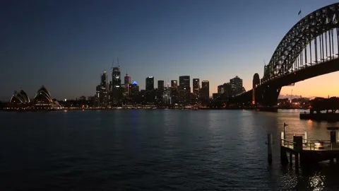 Dark timelapse of city of Sydney CBD waterfront across Harbour &amp; bridge–4k. Stock Footage 139570293